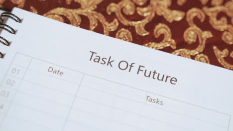 Opening-notebook-to-reveal-'Task-Of-Future'-Heading