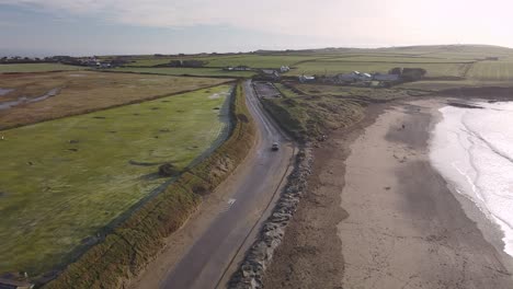 Winter-coastal-road-in-slow-motion-aerial,-Ireland