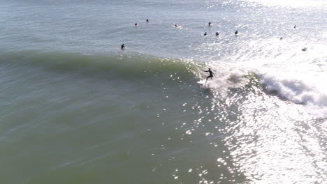 Aerial-drone-shot-of-a-man-surfing-a-wave-in-Durban-South-Africa-in-the-warm-Indian-Ocean