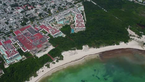 Drone-shot-of-the-Paradisus-Playa-del-Carmen-and-surrounding-tropical-waters-in-Mexico