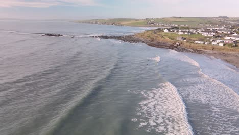 Some-surfers-tasting-frozen-winter-waves-on-Irish-shores-in-slow-motion-aerial