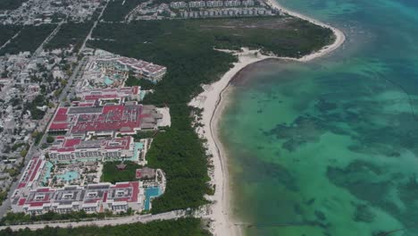 High-up-aerial-view-of-a-resort-bordering-the-Caribbean-Sea-in-Mexico