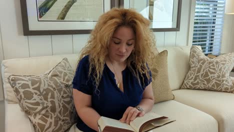 long-curly-blonde-hair-womand-reading-a-book-in-a-model-home