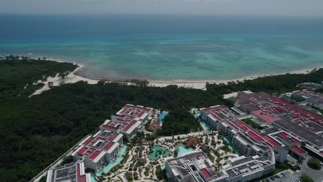 Drone-shot-flying-over-a-Mexican-resort-towards-the-Caribbean-sea