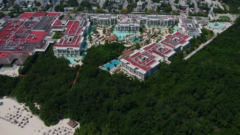 Wide-aerial-shot-pulling-away-from-Paradisus-Playa-del-Carmen-to-reveal-the-tropical-water-the-resort-borders