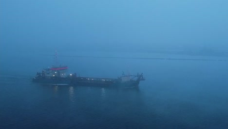 Drone-view-of-cargo-container-ship-sails-in-sea-fog