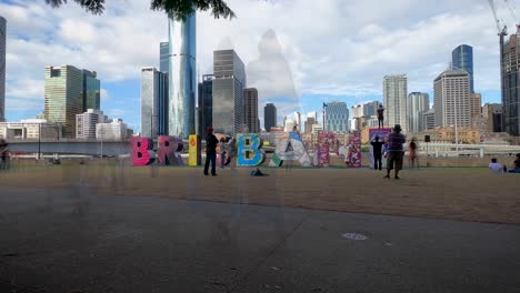 Wide-shot-of-the-people-climbing-Brisbane-sign,-time-lapse