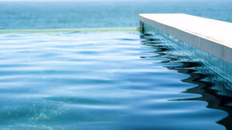 Niedrige-Statische-Aufnahme-Des-Sich-Bewegenden-Oberflächenwassers-Des-Blauen-Swimmingpools-Am-Pool