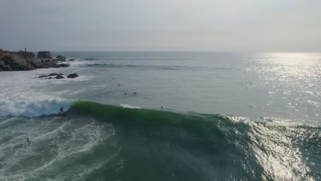 Aerial-view-surfer-thrown-from-surfboard-riding-Punta-Zicatela-shimmering-sunlit-waves,-Oaxaca,-Mexico