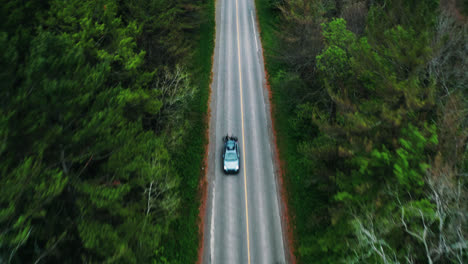 Aerial-Top-Down-View-of-Car-Reveal-Driving-Down-Empty-Forest-Road-Surrounded-by-Trees-Cinematic-Drone-Travel-Adventure-Vacation-4K