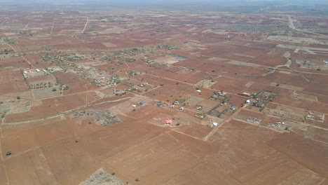 Beautiful-aerial-of-farms-in-a-dry-and-arid-landscape-in-rural-Kenya