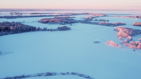 Frosty-cold-winter-countryside-landscape-in-sunrise-light-aerial-view