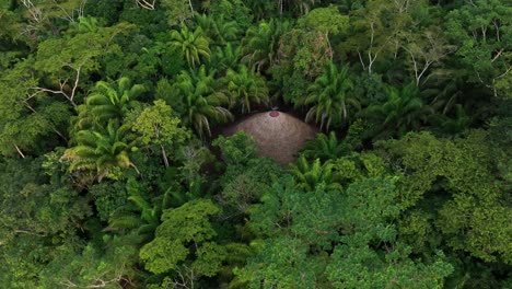 Aerial-drone-fly-view-of-Jungle-hut-in-the-Amazonia,-surrounded-by-trees,-rivers,-tropical-climate,-wild-animals,-rain-in-the-forest