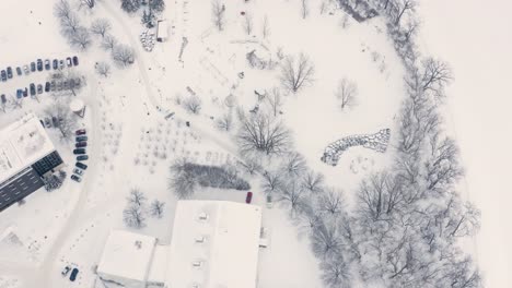 Aerial-descend-over-skating-pathways-at-The-Forks-in-winnipeg-Manitoba,-Canada