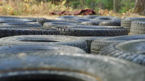 Old-Car-Tires-Placed-In-Rows-On-The-Ground-For-Obstacle-Training-Course
