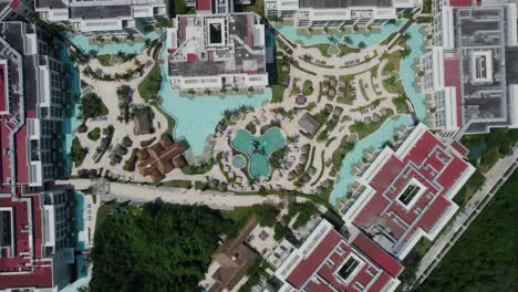 Lowering-aerial-view-of-the-lazy-river-water-system-at-a-resort-in-Mexico