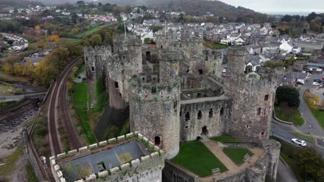 Historic-Conwy-castle-aerial-view-of-Landmark-town-ruin-stone-wall-battlements-tourist-attraction-flyover-closeup