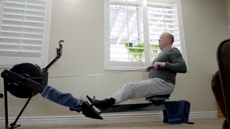 Senior-overweight-man-exercising-on-a-rowing-machine