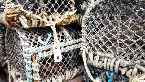 Stacked-empty-fishing-harbour-industry-lobster-net-baskets-closeup-dolly-left-slow