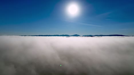 AERIAL-SIDE-SHOT-ABOVE-THE-CLOUDS-IN-WILKES-COUNTY-NC,-NORTH-CAROLINA