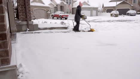 Senior-woman-shoveling-snow-from-her-driveway