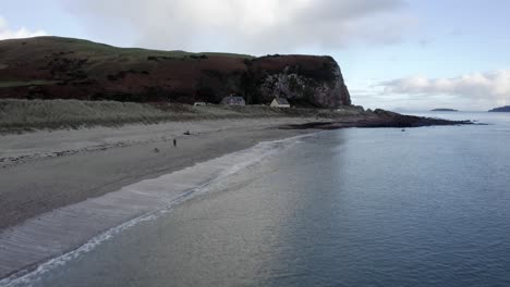 AERIAL---Southend-beach-in-Kintyre-Peninsula,-Scotland,-rising-reverse-shot