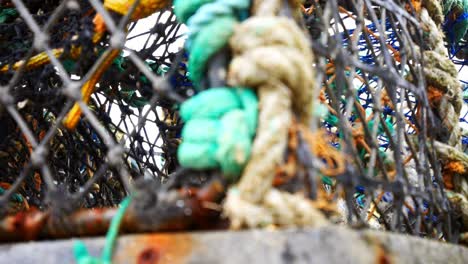 Stacked-empty-fisheries-industry-lobster-net-baskets-closeup-dolly-right