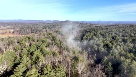aerial-push-in-over-wilkes-county-nc,-north-carolina-through-small-cloud