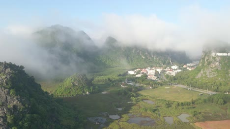Spanning-toward-the-village-with-misty-mountain-range-background