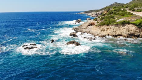 Beautiful-Beach-Natural-Landscape-With-Rocky-Shore-And-Green-Vegetation-Surrounded-By-Blue-Waters-On-A-Sunny-Day-At-Jerusalem-Beach-In-Kefalonia,-Greece