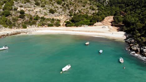 Small-Boats-Anchored-At-The-Remote-Jerusalem-Beach-In-Erisos,-Kefalonia,-Greece