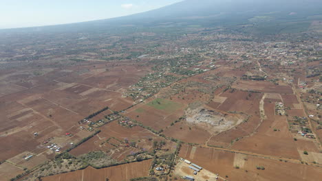 High-angle-reveal-of-a-distant-town-in-a-beautiful-landscape-in-Kenya