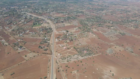 Aerial-reveal-of-distant-farms-and-house-in-rural-Kenya