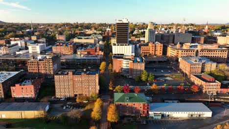 Rising-aerial-reveals-historic-downtown-Lynchburg,-Virginia,-USA-during-autumn-golden-magic-hour