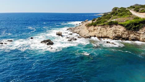 Coastal-Road-Near-The-Rocky-Cliff-Of-Jerusalem-Beach-In-Erisos-In-The-Ionian-Island-Of-Kefalonia,-Greece