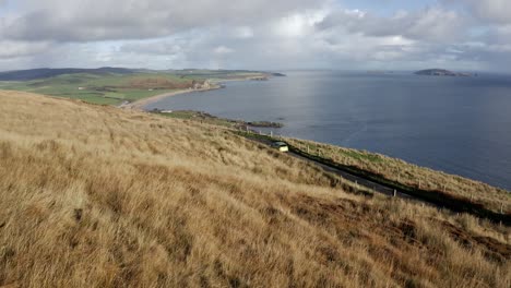 AERIAL---Mull-of-Kintyre,-horizon-and-coast,-Kintyre-Peninsula,-Scotland,-forward