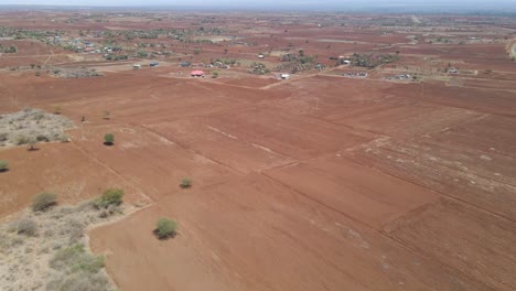 Flying-over-dust-covered-meadows-in-rural-Africa