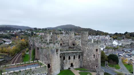 Historic-Conwy-castle-aerial-view-of-Landmark-town-ruin-stone-wall-battlements-tourist-attraction-rising-establishing-town-shot