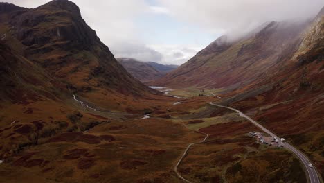 AERIAL---Epic-view-of-Glencoe,-the-Scottish-Highlands,-Scotland,-wide-shot-reverse