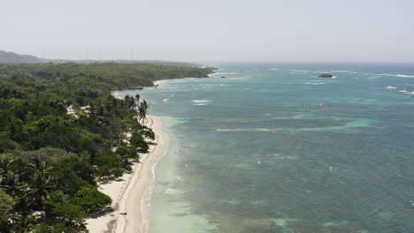 AERIAL---Sunny-beach-paradise,-Playa-Teco-Maimon,-Dominican-Republic,-forward