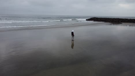 Solo-man-exploring-the-beach-during-a-beautiful-California-sunrise