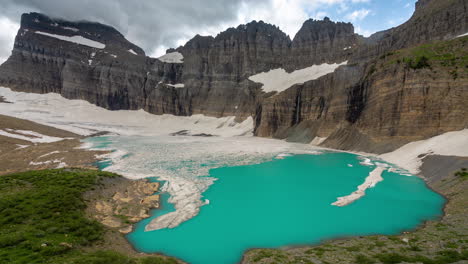 Time-Lapse,-Glacier-and-Aqua-Blue-Glacial-Water-Under-Mountain-Cliffs-and-Clouds-Iceberg-Lake,-Mount-Grinnell,-Glacier-National-Park,-Montana-USA