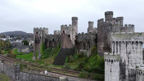 Historic-Conwy-castle-aerial-view-of-Landmark-town-ruin-stone-wall-battlements-tourist-attraction-rising-right-above-skyline