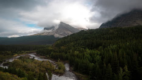 Time-Lapse,-Dramatic-Clouds-Above-Majestic-Pristine-Mountains-Landscape,-Forest,-Glacial-River-and-Peaks