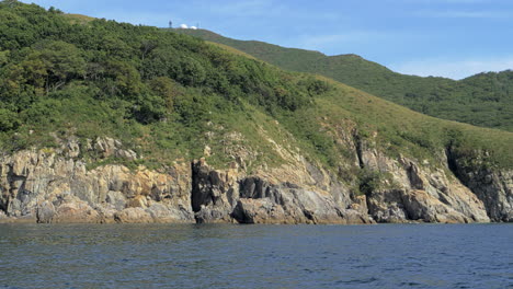 Boat-sails-parallel-to-a-rocky-shore-in-Primorye-Bay