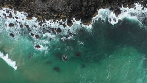 4k-Drone-shot-of-ocean-waves-crashing-on-to-rocky-coastline-and-mountain-cliff-in-Australia