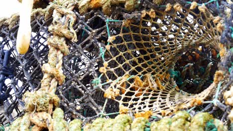 Stacked-empty-fishing-industry-lobster-net-baskets-closeup-dolly-left-looking-up