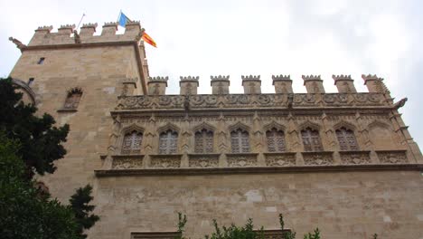 Old-And-Historic-Lonja-de-la-Seda-Building-With-Flags-In-Valencia,-Spain