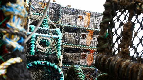 Stacked-empty-fishing-industry-lobster-bait-net-baskets-closeup-dolly-right