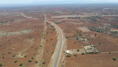 Jib-down-of-long-highway-in-rustic-Kenyan-countryside